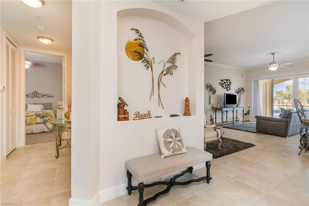 Image 4: Hallway with baseboards and light tile patterned flooring