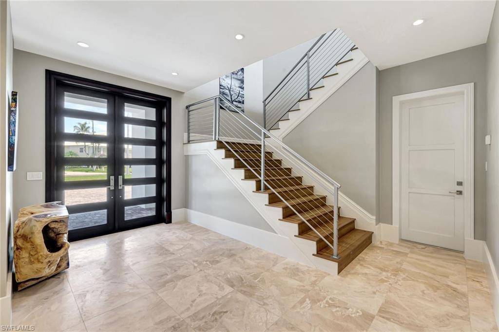 Image 3: Entrance foyer featuring french doors, stairway, marble finish floors, baseboards, and recessed lighting