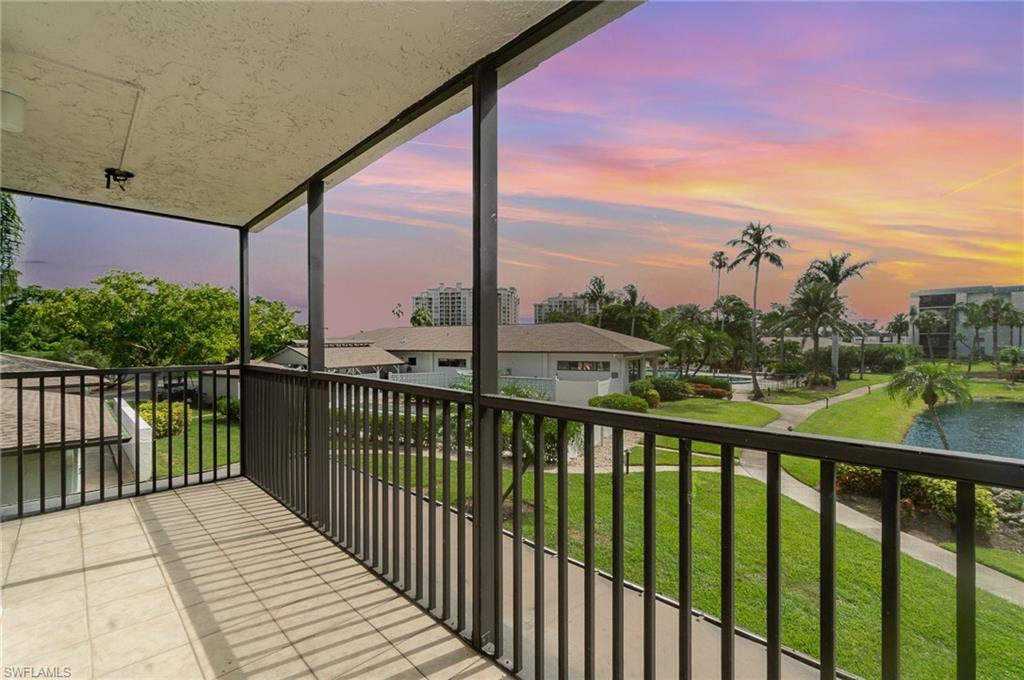 Image 2: Balcony at dusk, overlooks pond and lush, tropical grounds