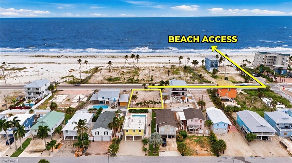 Image 1: VIRTUALLY ENHANCED - Aerial view of a coastal property, highlighting proximity to a sandy beach