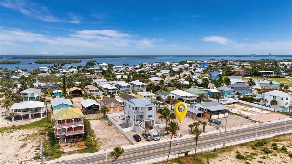 Image 2: VIRTUALLY ENHANCED - Aerial perspective showcasing a coastal community with bay access