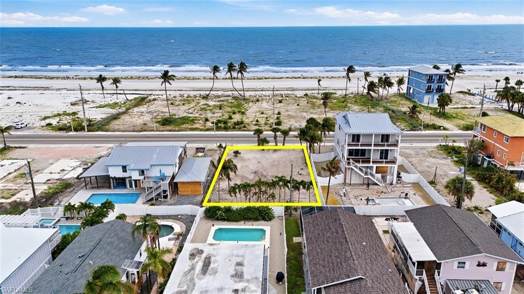 Image 3: VIRTUALLY ENHANCED - Beachfront lot featuring direct access to the sand, mature palm trees, and ocean frontage