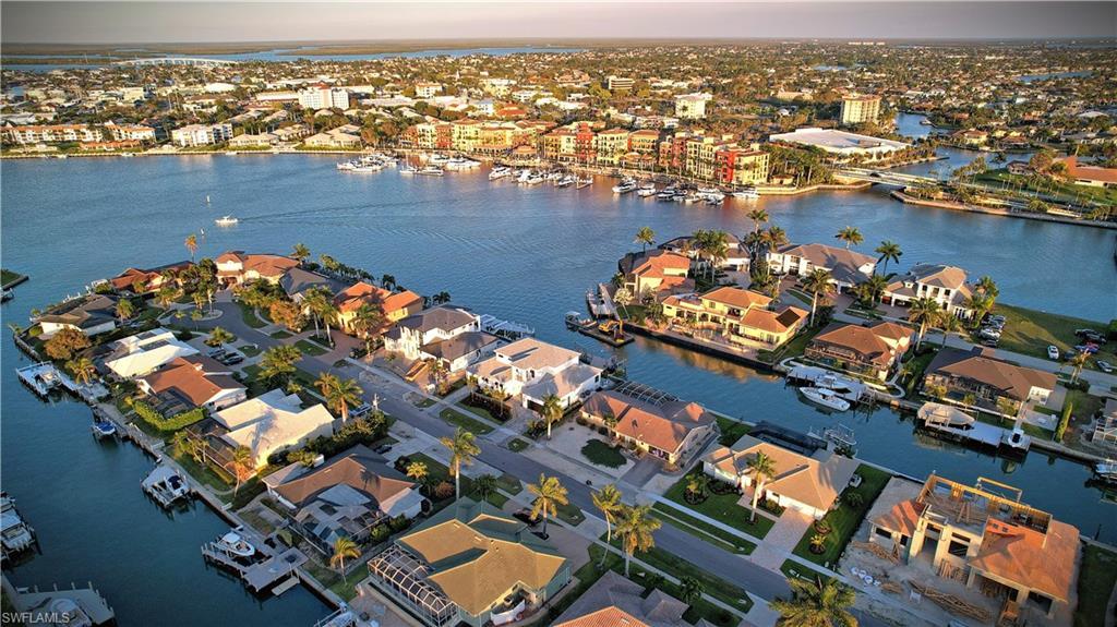 Image 2: Aerial view of property and surrounding area featuring a nearby body of water and nearby suburban area