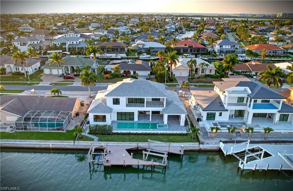 Image 4: Aerial perspective of suburban area with a large body of water