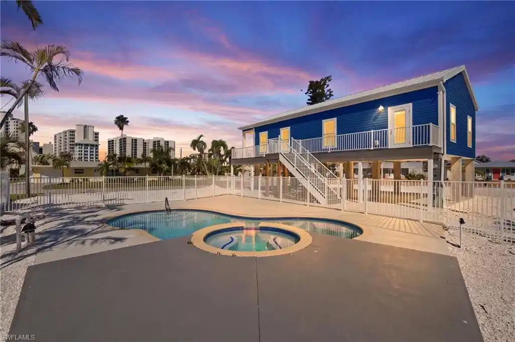 Image 1: Elevated blue exterior with white trim and a metal roof - Virtually Edited Image