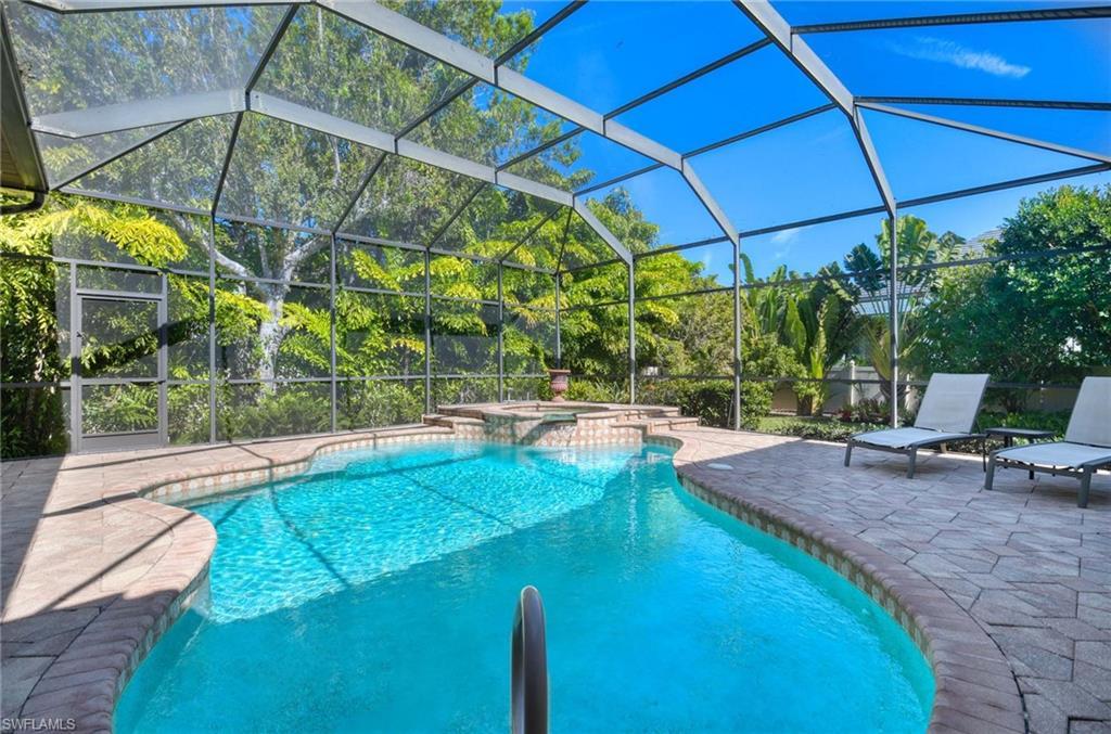 Image 4: View of swimming pool with a patio area, glass enclosure, a pool with connected hot tub, and a sunroom