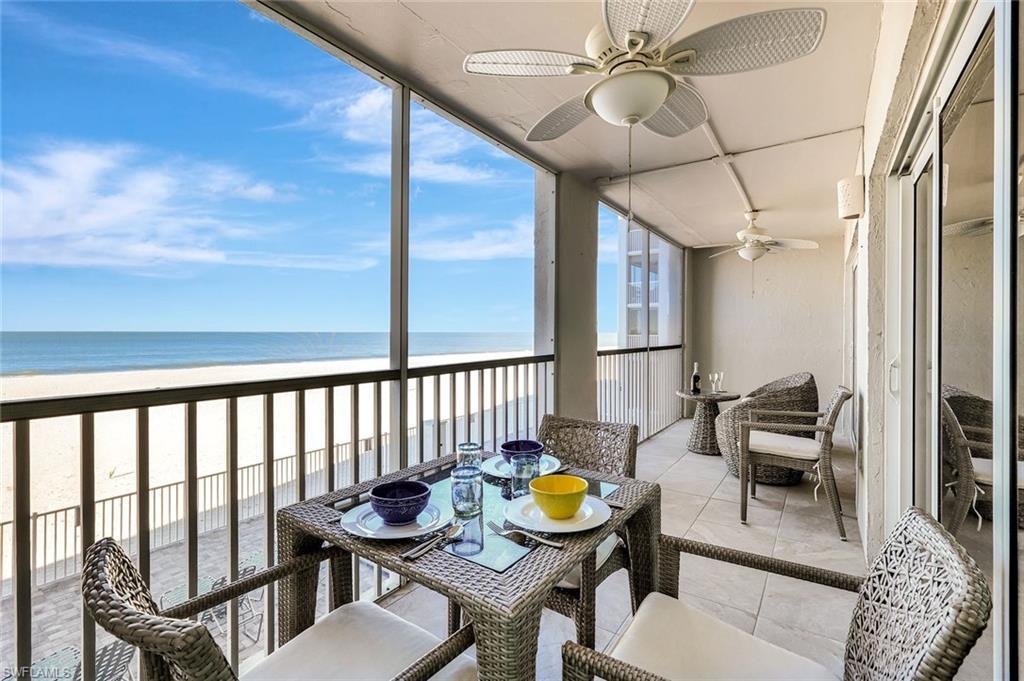Image 2: Sunroom / solarium featuring ceiling fan, a balcony, view of water and beach, and outdoor dining area