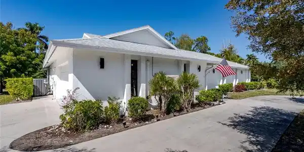 Image 2: Home featuring stucco siding, concrete driveway, a garage, and roof with shingles