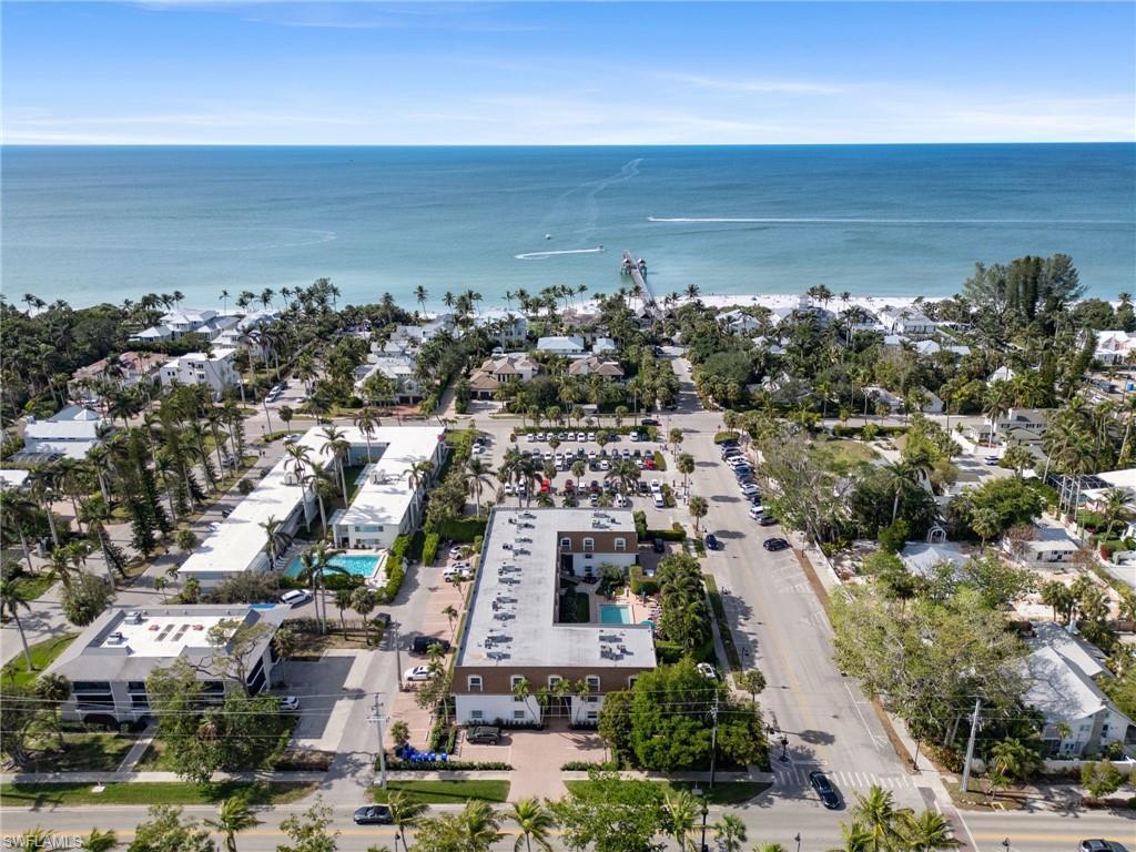 Image 1: Aerial perspective of suburban area with a nearby body of water