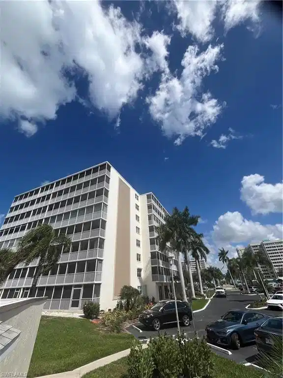 Image 1: View of apartment building / complex featuring uncovered parking