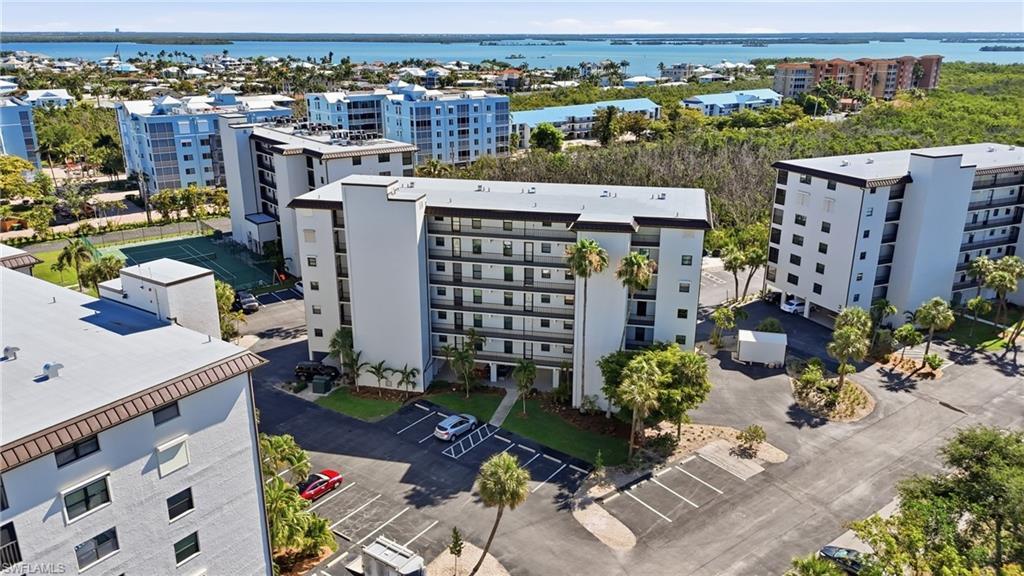 Image 3: Multi-story condominium building featuring a contemporary design with multiple balconies - Virtually Edited Image