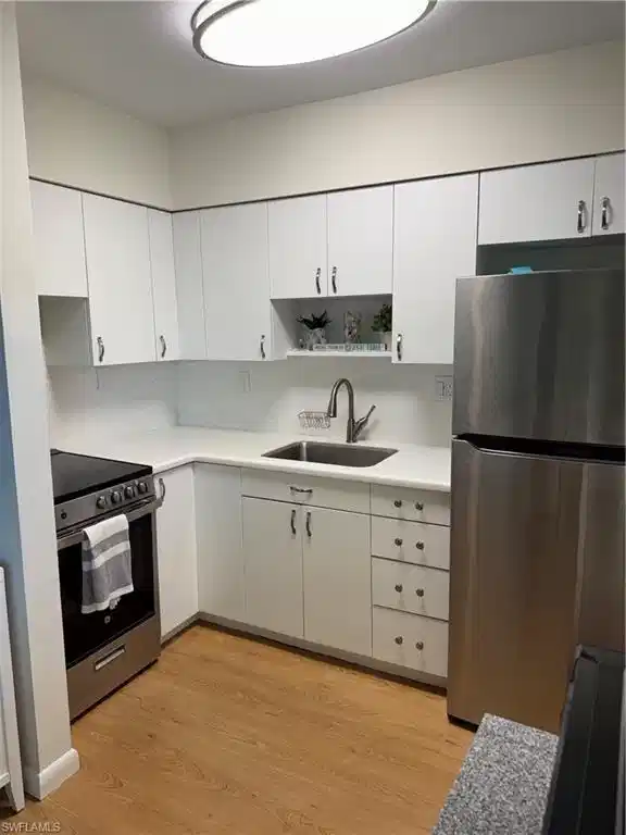 Image 1: Updated cabinetry, quartz countertops and backsplash, stainless steel appliances