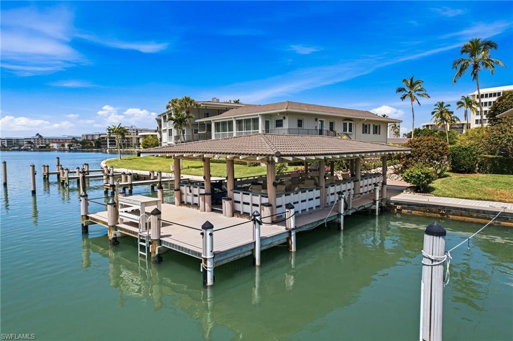Image 4: RESORT-STYLE AMENITIES, including a pool, bayfront pavilion ideal for entertaining or watching dolphins beneath breathtaking sunset skies, a clubhouse with year-round social events, and GULF-ACCESS BOAT SLIPS AVAILABLE FOR LEASE (subject to availability).