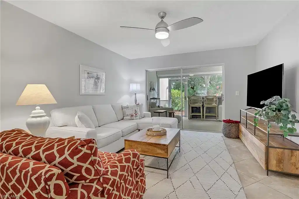Image 1: Living room with access to sitting room, northern exposure; primary bedroom to the right