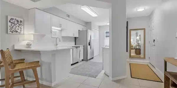 Image 2: Quartz countertops; entrance to the condo is to the right of the photo