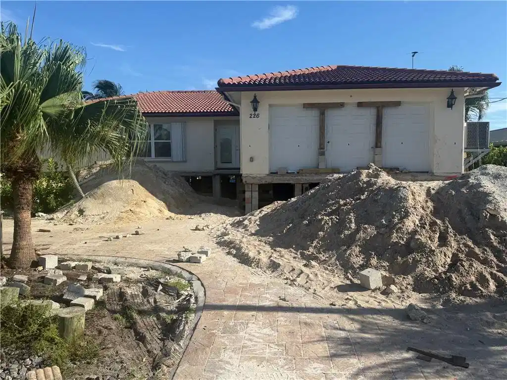 Image 1: House is now lifted 4 ft. It is in process to be lifted 12 ft.