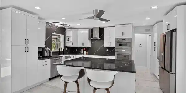Image 3: Quartz counters, backsplash, and huge island. Thermador wall oven, speed oven, and Freedom induction cooktop.