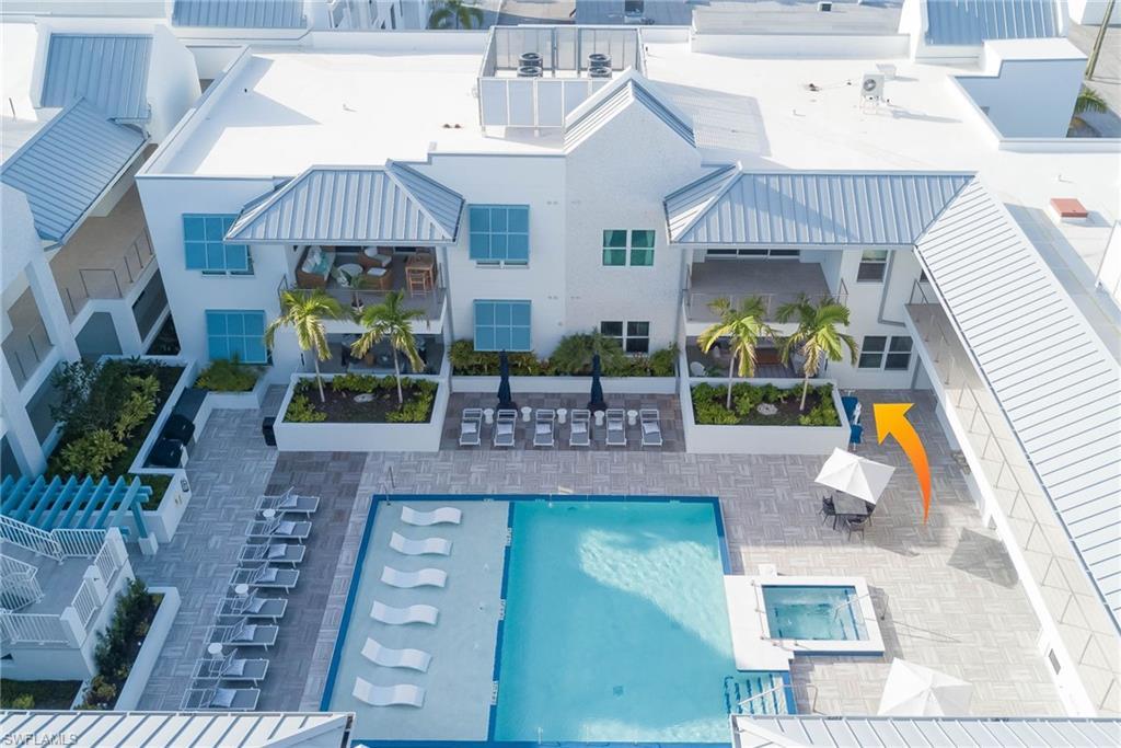 Image 3: Community pool with a patio area on the 2nd level amenity deck- unit is on this level for easy access
