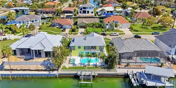 Image 2: Waterfront property featuring an extensive seawall, private dock, and boat lift