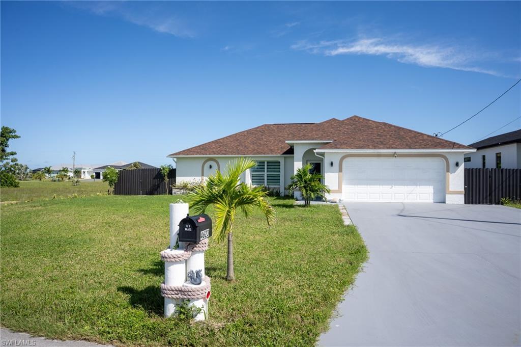 Image 2: View of front of house with stucco siding, concrete driveway, an attached garage, and a shingled roof