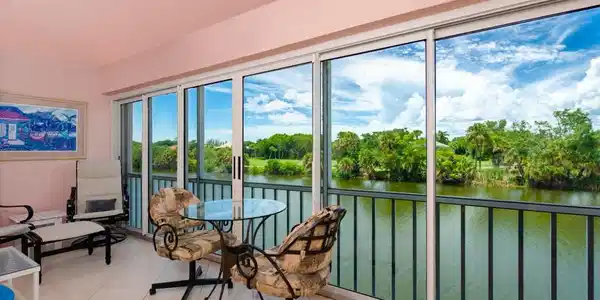 Image 4: Sunroom featuring a water view and view of wooded area
