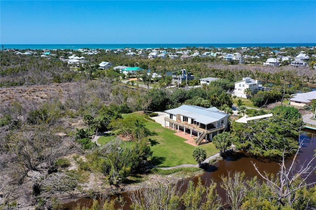 Image 4: Aerial view of property and surrounding area featuring a large body of water