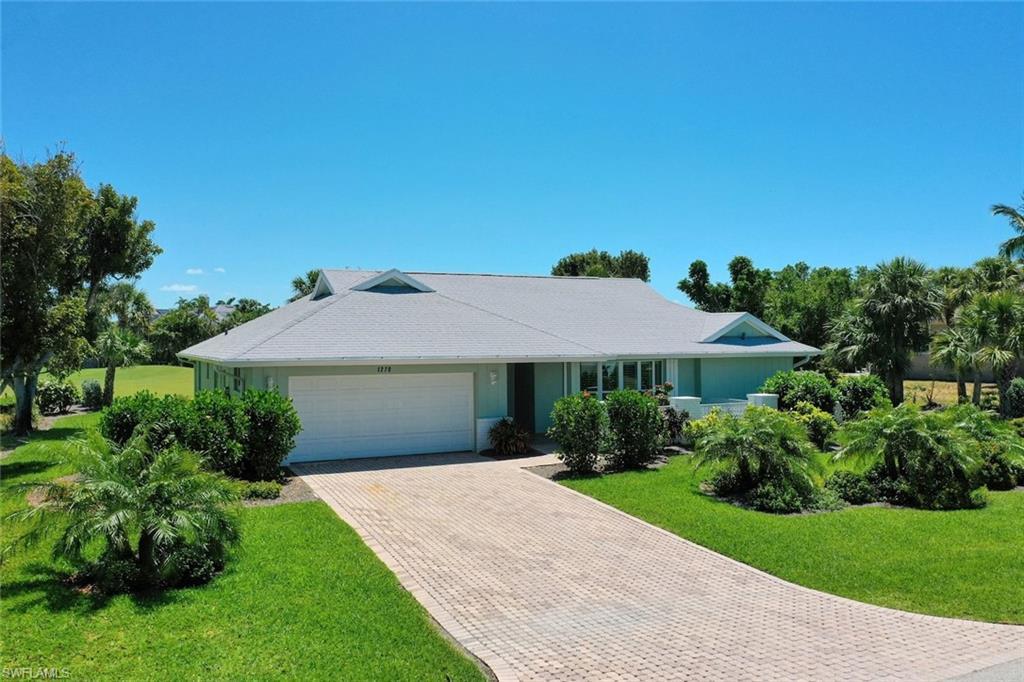 Image 2: Single story home with a front lawn, an attached garage, and decorative driveway