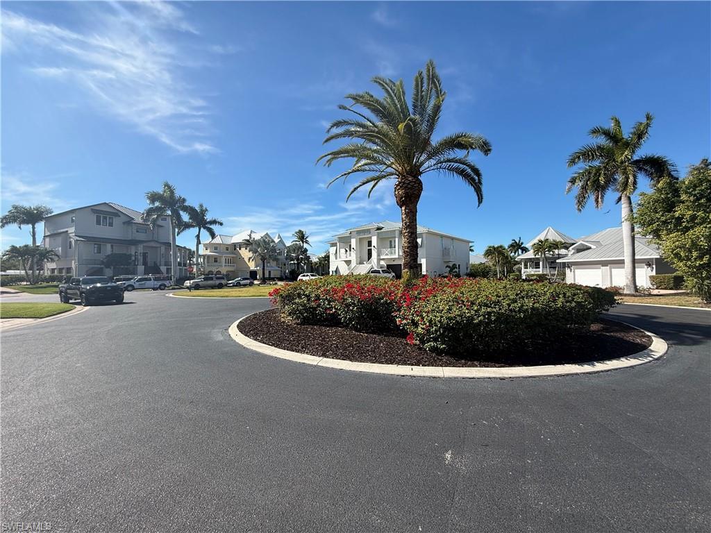 Image 3: View of asphalt road with curbs and a residential view