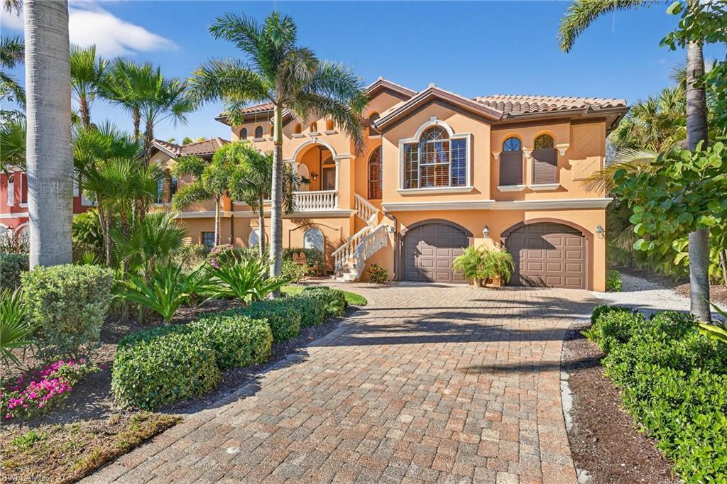 Image 1: Mediterranean / spanish-style home featuring decorative driveway, stucco siding, a tiled roof, an attached garage, and a balcony