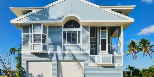 Image 2: View of front of property featuring decorative driveway, a garage, and a balcony