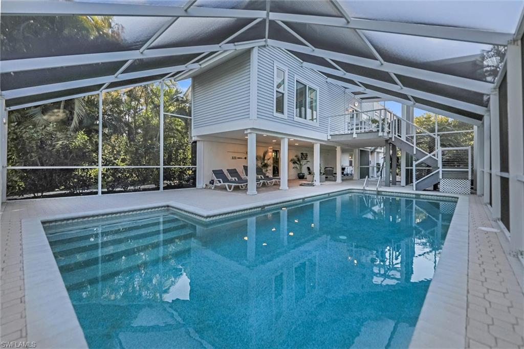 Image 3: Outdoor pool featuring a sunroom, glass enclosure, and a patio area