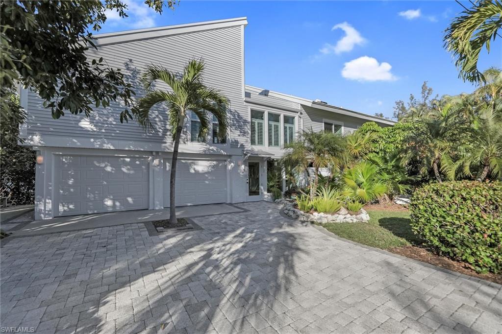 Image 4: View of front of property with a garage and driveway