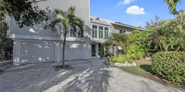 Image 4: View of front of property with a garage and driveway
