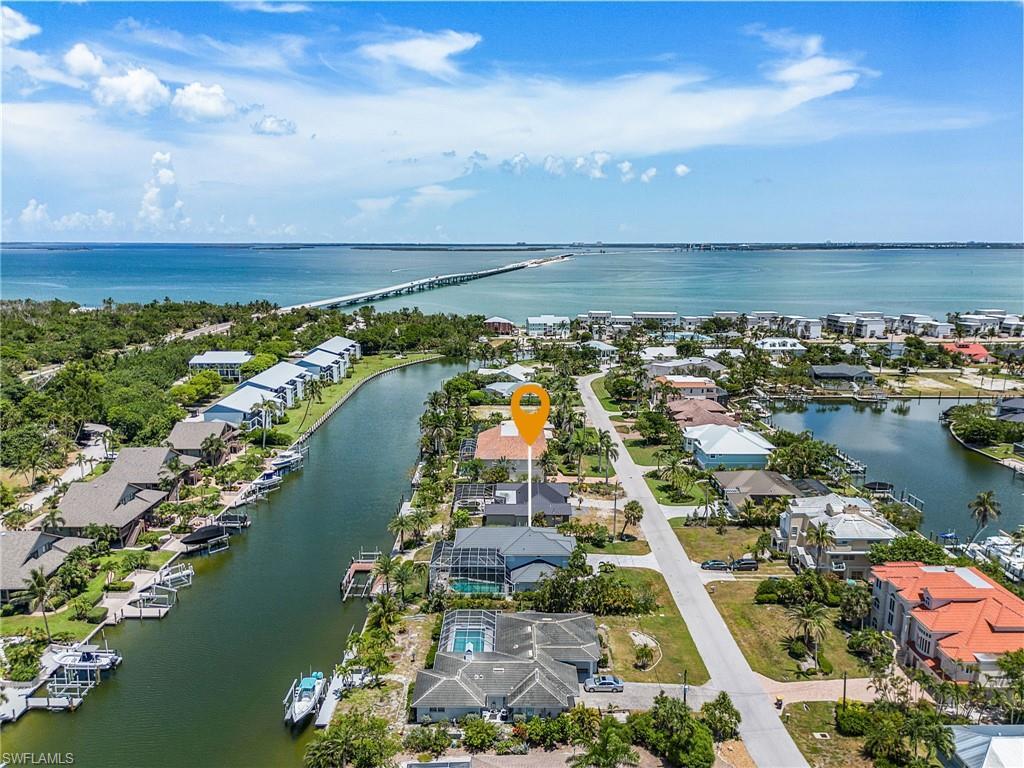 Image 2: Aerial view of residential area with a large body of water