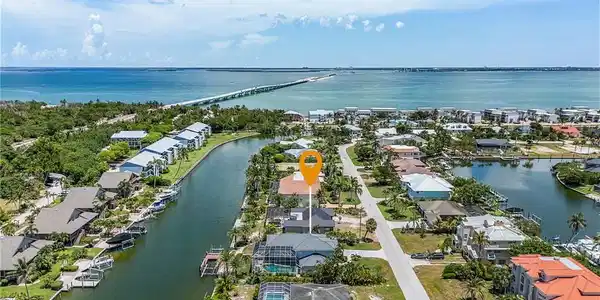 Image 2: Aerial view of residential area with a large body of water