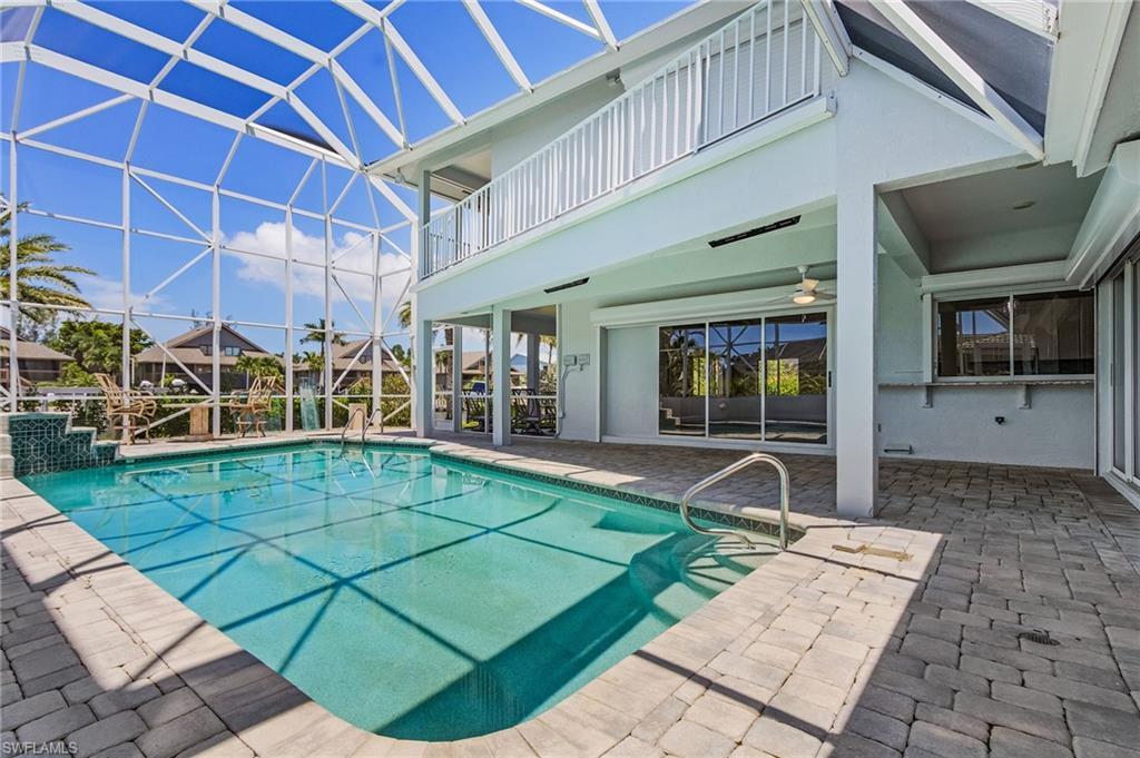 Image 3: Swimming pool with a patio, a sunroom, a lanai, and a balcony