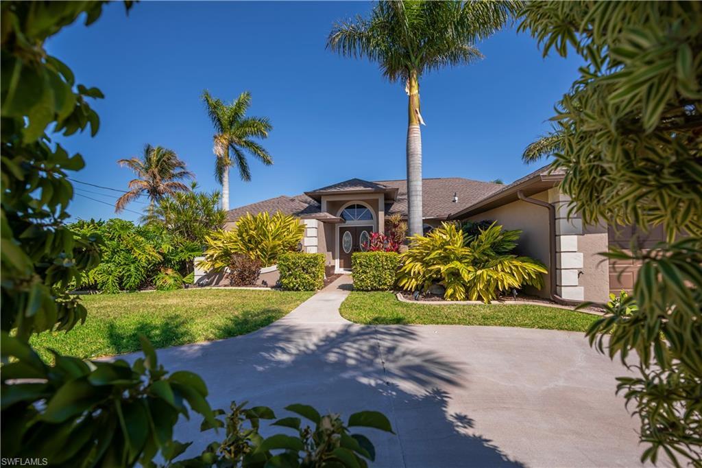Image 2: Mediterranean / spanish home with stucco siding and a front lawn