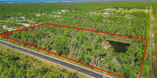 Image 2: View of property location featuring property boundaries highlighted and a heavily wooded area