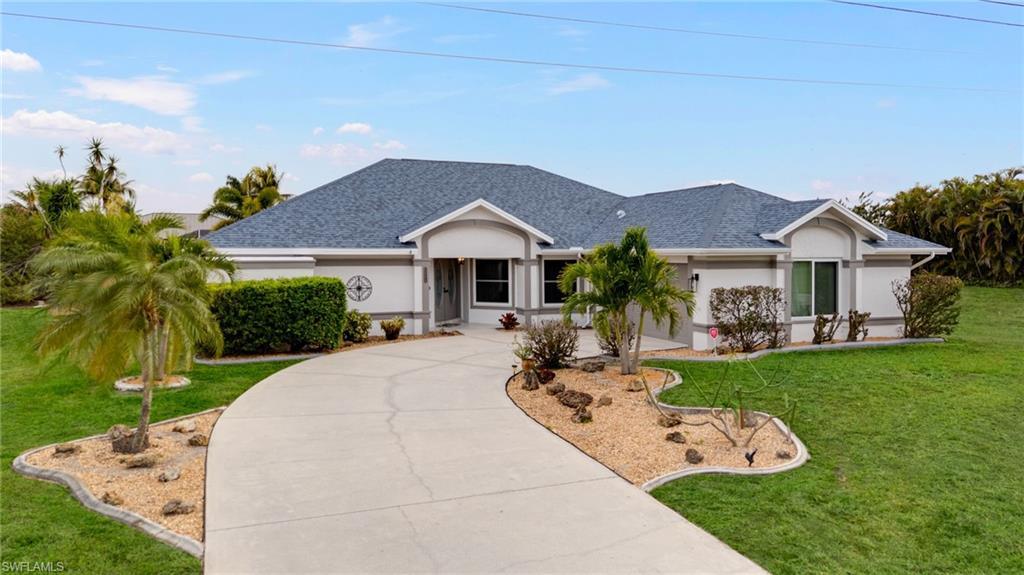 Image 2: Single story home featuring a front lawn, stucco siding, roof with shingles, and concrete driveway
