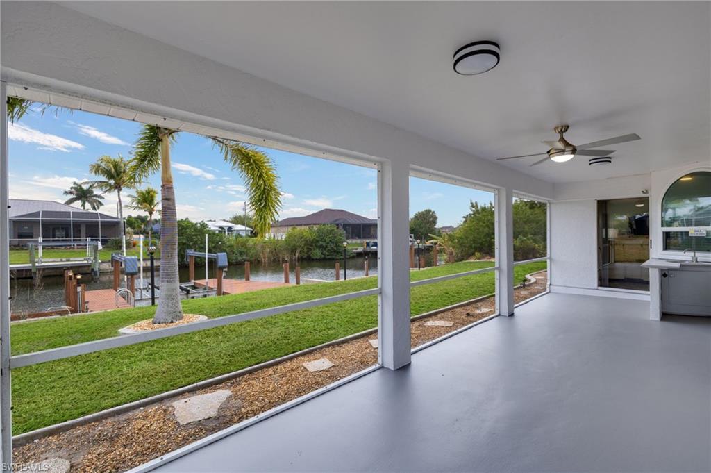 Image 3: Unfurnished sunroom featuring ceiling fan, a water view, and a patio