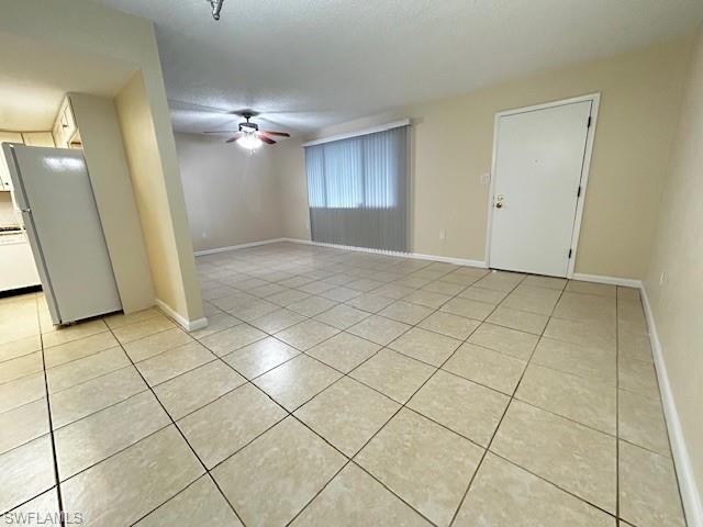 Image 2: Unfurnished room with a textured ceiling, a ceiling fan, and light tile patterned flooring