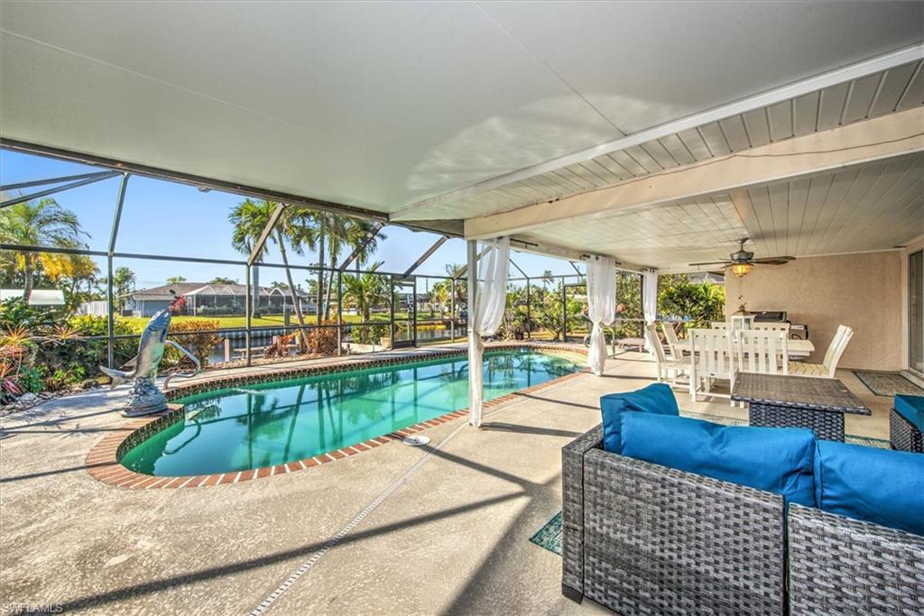 Image 4: Outdoor pool with a patio, outdoor lounge area, a sunroom, and a lanai