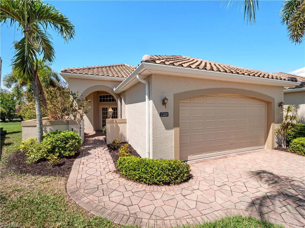 Image 1: Mediterranean / spanish-style house with stucco siding, an attached garage, a tile roof, and driveway