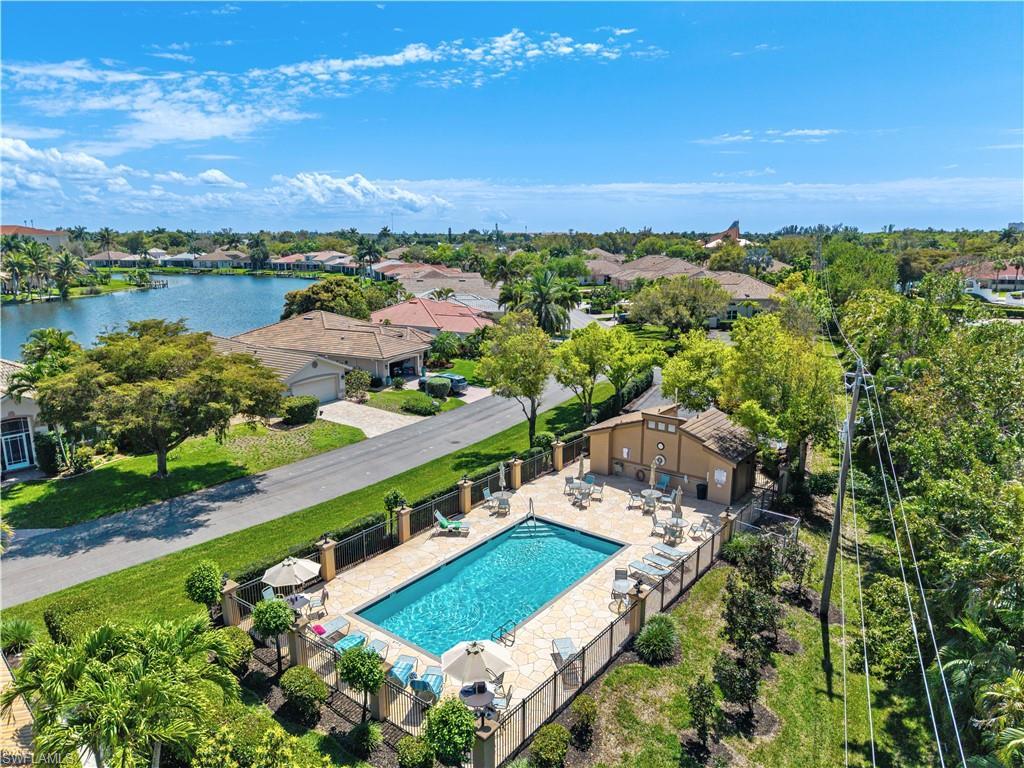 Image 3: Community pool with a patio area and a water view