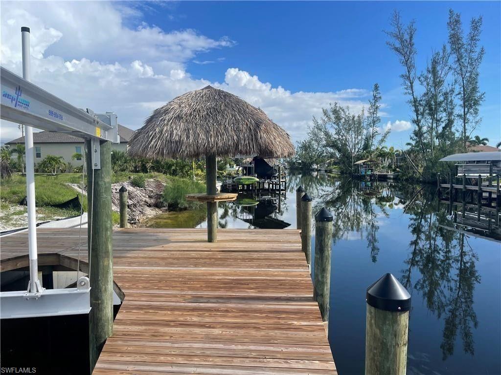 Image 3: Dock featuring a water view