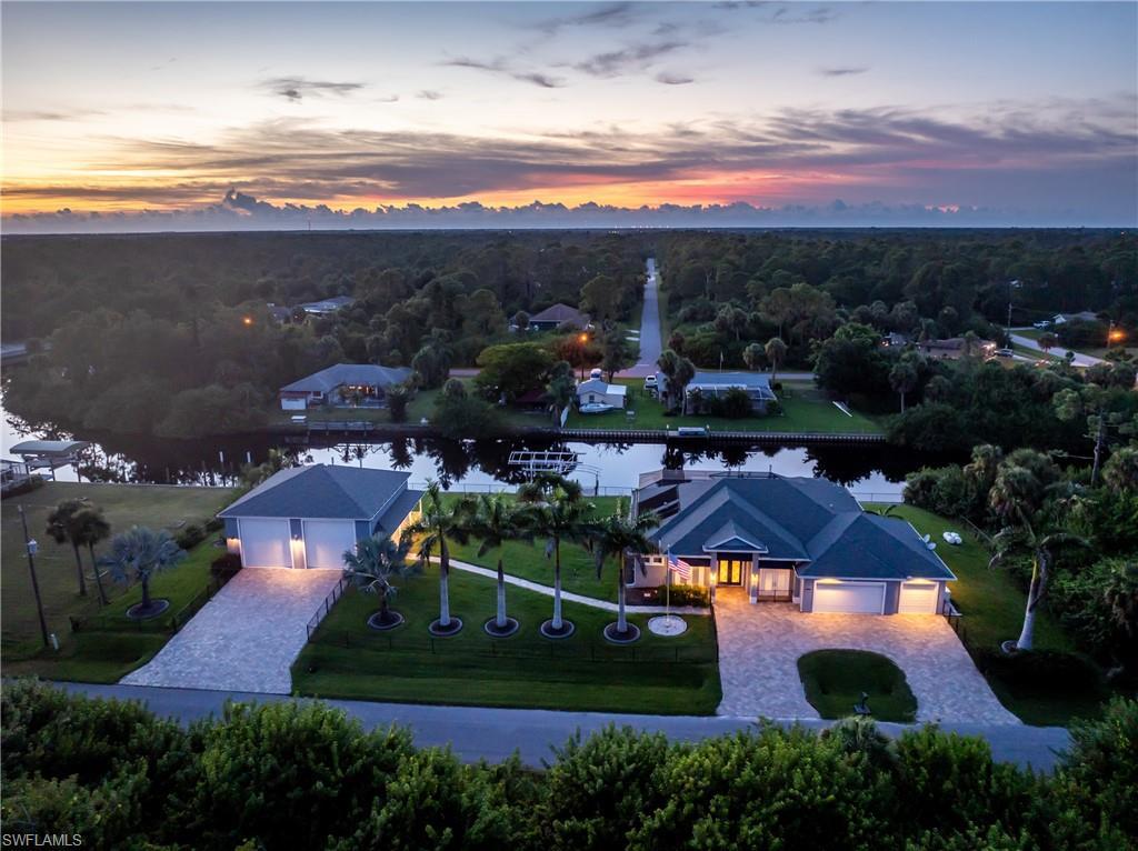 Image 1: Aerial view of property and surrounding area featuring a tree filled landscape