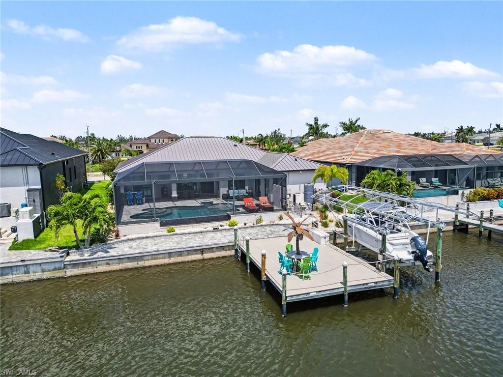 Image 3: The property features a screened-in lanai with a swimming pool and spa