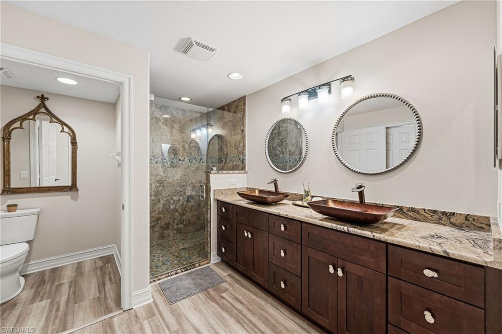 Image 1: The primary ensuite bath has been freshly painted in soft, neutral tones, creating a serene and inviting atmosphere.