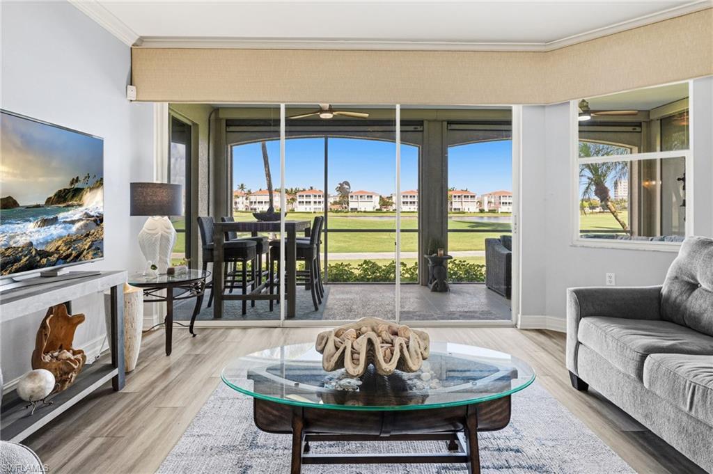 Image 4: The main living area captures panoramic views of the lake and golf course, while a thoughtfully curated new furniture design enhances the sense of openness and spaciousness.