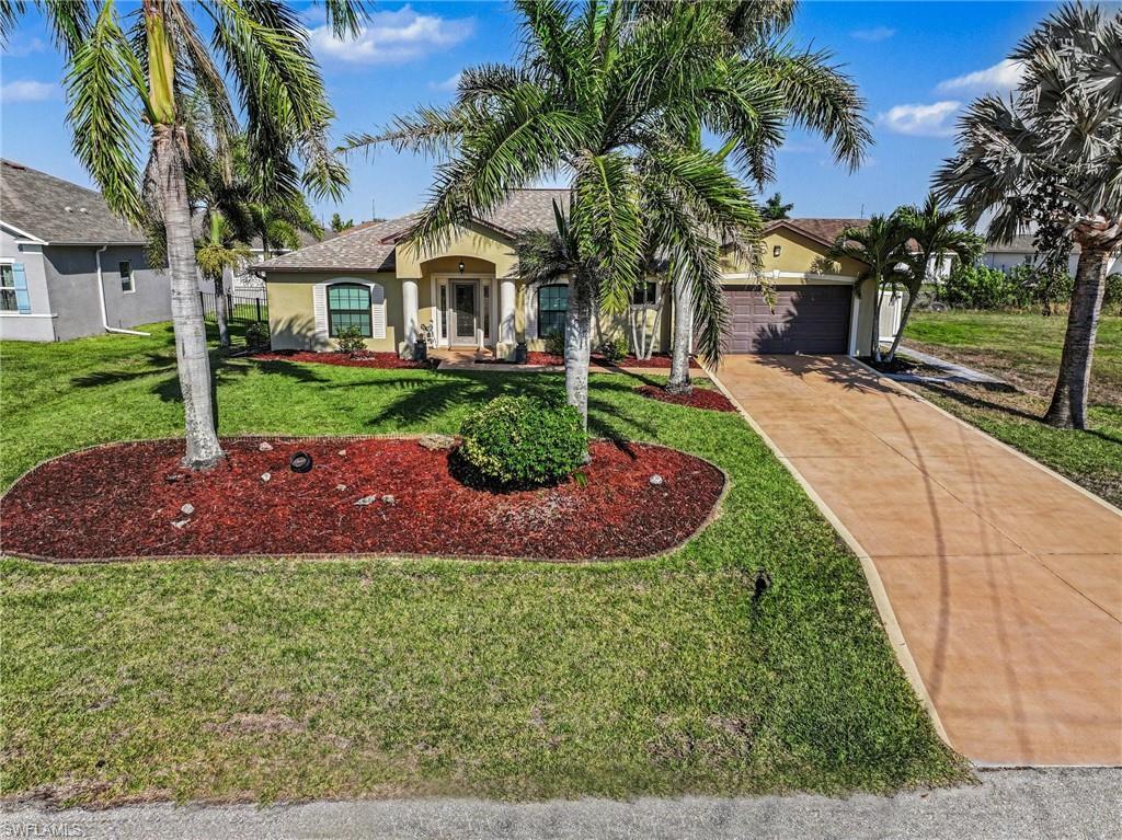 Image 1: View of front of house with stucco siding, concrete driveway, an attached garage, and a front yard